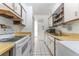 Efficient kitchen layout with updated appliances and ample storage space next to the laundry area at 501 E Bay Dr # 102, Largo, FL 33770