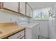Practical laundry area with side-by-side machines and storage space next to the kitchen at 501 E Bay Dr # 102, Largo, FL 33770