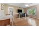 Bright living room featuring hardwood floors, a ceiling fan, and a window with natural light at 501 E Bay Dr # 102, Largo, FL 33770