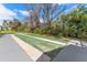 Community shuffleboard court surrounded by lush greenery offering a recreational space for residents at 501 E Bay Dr # 102, Largo, FL 33770