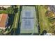 Aerial view featuring a well-maintained tennis court and landscaping at 501 E Bay Dr # 102, Largo, FL 33770