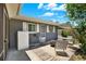 Backyard patio with table, seating, fire pit and gray exterior wall at 5068 Lakewood Dr, Ridge Manor, FL 33523
