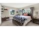 Bedroom with wood furniture, a bed with a patterned blanket, and two windows at 5068 Lakewood Dr, Ridge Manor, FL 33523