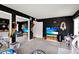 Well-lit Bedroom with dark walls, toys, seating and desk at 5068 Lakewood Dr, Ridge Manor, FL 33523