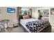 Bedroom featuring wood furniture, and bed with patterned blanket and a sliding closet at 5068 Lakewood Dr, Ridge Manor, FL 33523