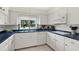 Classic kitchen with white cabinets, blue countertops, and modern appliances for your cooking needs at 5068 Lakewood Dr, Ridge Manor, FL 33523