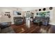 Bright living room features beautiful wood floors, comfortable seating, and sliding glass doors at 5068 Lakewood Dr, Ridge Manor, FL 33523