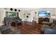 Cozy living room featuring hardwood floors, comfortable seating, and a fireplace for relaxing evenings at 5068 Lakewood Dr, Ridge Manor, FL 33523