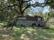 Old vehicle in backyard, overgrown at 5279 Eureka Springs Rd, Tampa, FL 33610