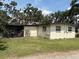 The backyard features a screened-in porch and a simple exterior at 5279 Eureka Springs Rd, Tampa, FL 33610