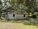 Backyard shed with a rusted metal roof and windows at 5279 Eureka Springs Rd, Tampa, FL 33610