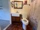 Bathroom features a new vanity with sink, toilet, and a well lit mirror at 5279 Eureka Springs Rd, Tampa, FL 33610
