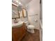 Bathroom with wood vanity, mirror, toilet and a clear glass shower enclosure at 5279 Eureka Springs Rd, Tampa, FL 33610