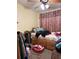 Bedroom with full-size bed, many storage drawers, and a ceiling fan with light fixture at 5279 Eureka Springs Rd, Tampa, FL 33610