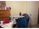 Modest bedroom with clothing, toys, and an ironing board; needs decluttering before listing at 5279 Eureka Springs Rd, Tampa, FL 33610