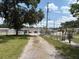 Long gravel driveway leading to the property with ample parking space at 5279 Eureka Springs Rd, Tampa, FL 33610