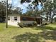 Charming single-story home featuring a mix of brick and siding, complemented by a well-maintained lawn and landscaping at 5279 Eureka Springs Rd, Tampa, FL 33610