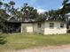 Exterior view of cozy home with green lawn, blending charm with outdoor appeal at 5279 Eureka Springs Rd, Tampa, FL 33610