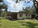 Exterior view of cozy home with green lawn and mature landscaping, blending charm with outdoor appeal at 5279 Eureka Springs Rd, Tampa, FL 33610