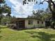 Quaint single-story home with brick accents and a green lawn at 5279 Eureka Springs Rd, Tampa, FL 33610