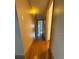 Hallway with wood-look flooring and neutral colored walls at 5279 Eureka Springs Rd, Tampa, FL 33610