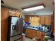 Kitchen with wooden cabinets and stainless steel appliances at 5279 Eureka Springs Rd, Tampa, FL 33610