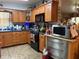 Kitchen with wood cabinetry, stainless steel appliances, and tile flooring at 5279 Eureka Springs Rd, Tampa, FL 33610
