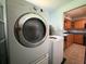 Laundry area with modern washer and dryer next to kitchen, enhancing convenience and efficiency at 5279 Eureka Springs Rd, Tampa, FL 33610