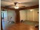 Living room featuring hardwood floors, a ceiling fan, and connected rooms at 5279 Eureka Springs Rd, Tampa, FL 33610