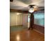 View of the living room featuring wood-look floors, ceiling fan, and natural light at 5279 Eureka Springs Rd, Tampa, FL 33610