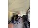 View of a covered patio filled with various household items, providing extra outdoor living space at 5279 Eureka Springs Rd, Tampa, FL 33610