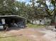 Exterior of a metal shed, surrounded by green grass, showcasing storage space on the property at 5279 Eureka Springs Rd, Tampa, FL 33610