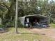 Exterior of shed, nestled among lush greenery, offering practical storage solutions and more at 5279 Eureka Springs Rd, Tampa, FL 33610