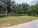 Expansive yard with mature trees, offering privacy and a serene environment at 5279 Eureka Springs Rd, Tampa, FL 33610