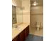 Bathroom vanity with large mirror, toilet and tile floor has decorative wallpaper border at 5804 Red Cedar Ln # 5804, Tampa, FL 33625