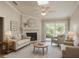 Bright living room with neutral tones, featuring a fireplace, comfortable seating, and a view of the outdoors at 5804 Red Cedar Ln # 5804, Tampa, FL 33625