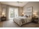 Serene bedroom featuring a bed, neutral decor, and a balcony offering an inviting and relaxing atmosphere at 5804 Red Cedar Ln # 5804, Tampa, FL 33625