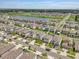 An aerial view of a well-maintained community with lush landscaping and a central lake, offering a serene and picturesque setting at 7211 Ronnie Gardens Ct, Tampa, FL 33619
