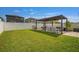 Spacious backyard with a covered patio and well-maintained lawn, perfect for outdoor activities at 7211 Ronnie Gardens Ct, Tampa, FL 33619