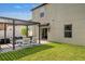 Green backyard featuring a pergola-covered patio and ample lawn space at 7211 Ronnie Gardens Ct, Tampa, FL 33619
