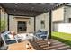 Outdoor living area with patio furniture, string lights, and a covered pergola at 7211 Ronnie Gardens Ct, Tampa, FL 33619