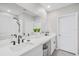 Bathroom with dual sinks, modern fixtures, and a large mirror over a white countertop at 7211 Ronnie Gardens Ct, Tampa, FL 33619