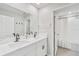 Elegant bathroom with double vanity, white marble countertops, and modern black fixtures at 7211 Ronnie Gardens Ct, Tampa, FL 33619