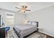 Comfortable bedroom featuring hardwood floors, a cozy bed, and ample natural light from the window at 7211 Ronnie Gardens Ct, Tampa, FL 33619
