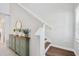 Bright foyer featuring wood floors, staircase, and green storage cabinet at 7211 Ronnie Gardens Ct, Tampa, FL 33619