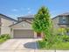 Charming two-story home features a two-car garage, manicured lawn, and inviting curb appeal at 7211 Ronnie Gardens Ct, Tampa, FL 33619