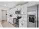 Modern kitchen with white cabinetry, stainless steel appliances, and sleek countertops at 7211 Ronnie Gardens Ct, Tampa, FL 33619