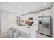 Modern kitchen with white cabinetry, stainless steel appliances, and a spacious center island at 7211 Ronnie Gardens Ct, Tampa, FL 33619