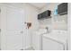 Functional laundry room with washer, dryer, and overhead shelving for storage at 7211 Ronnie Gardens Ct, Tampa, FL 33619