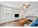 Bright living room featuring hardwood floors, a modern ceiling fan, and comfortable seating at 7211 Ronnie Gardens Ct, Tampa, FL 33619